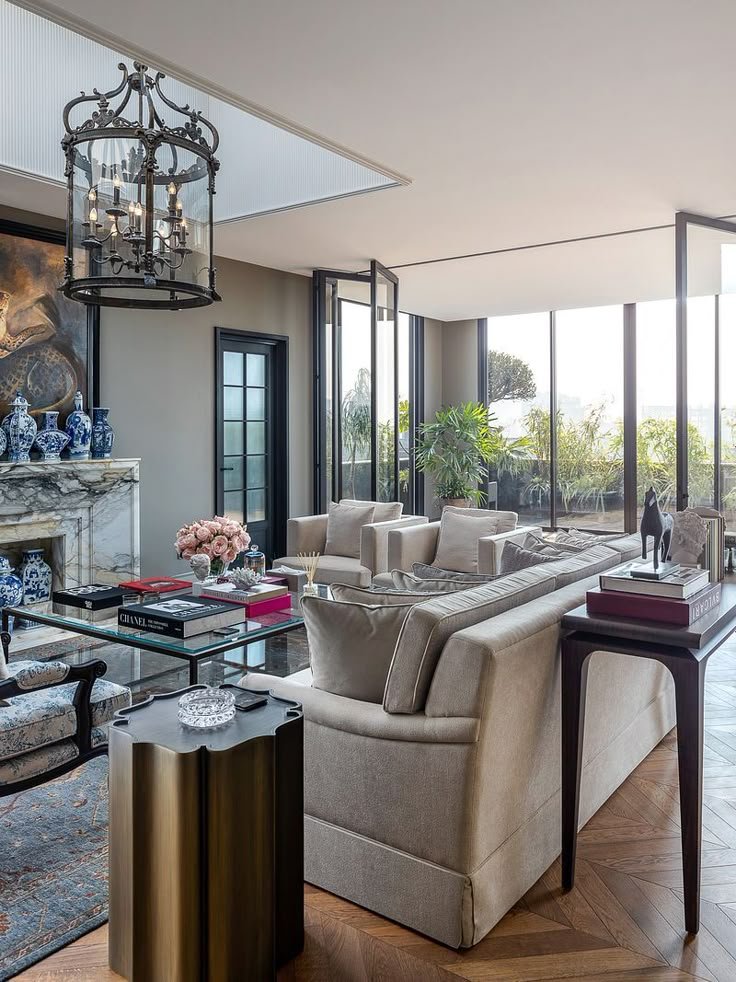 Interior view of a beautifully designed living room with elegant furniture and a chandelier. Discover premium homes and luxury residential properties in Noida, Ghaziabad, and Hapur with the top Real Estate Agency in Delhi NCR.