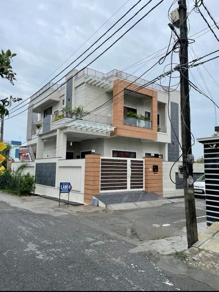 Exterior view of a modern, multi-story residential house. We offer a wide range of budget-friendly properties and affordable homes for sale in Hapur, Noida, and Ghaziabad.